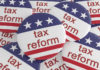 USA Politics News Badge: Pile of Tax Reform Buttons With US Flag