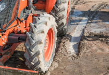 tractor working in a field and tire on the wet mud