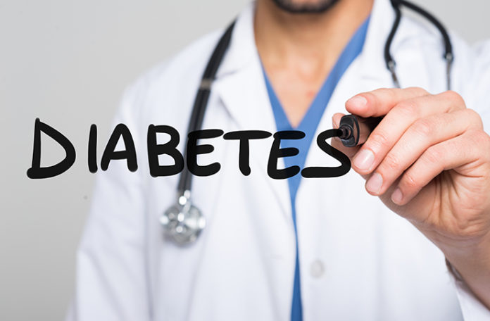 Doctor writing the word Diabetes