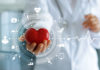 Medicine doctor holding red heart shape in hand