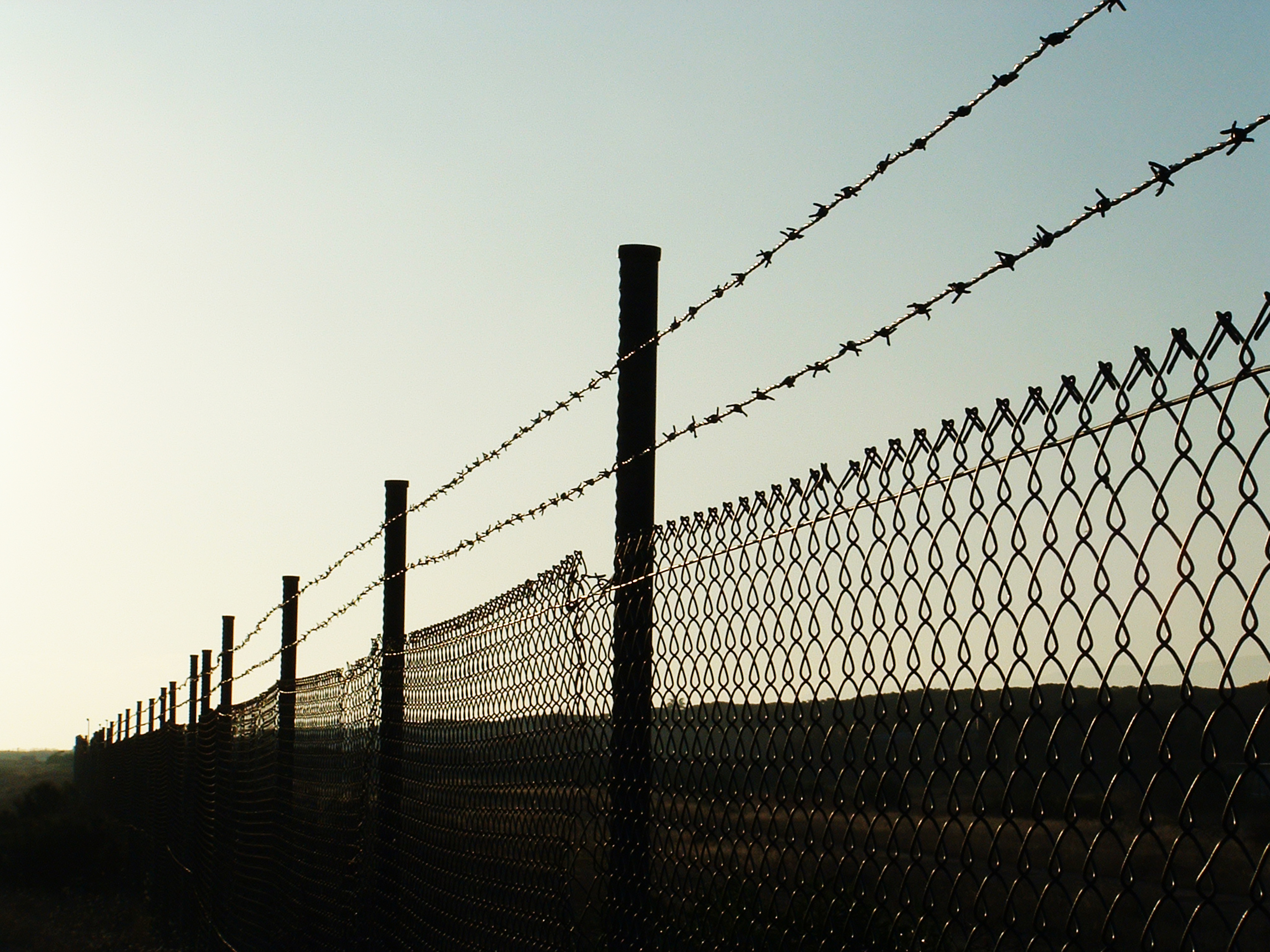 landscape with barbed wire /fence on sunset