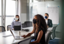 Business people wearing masks in a meeting